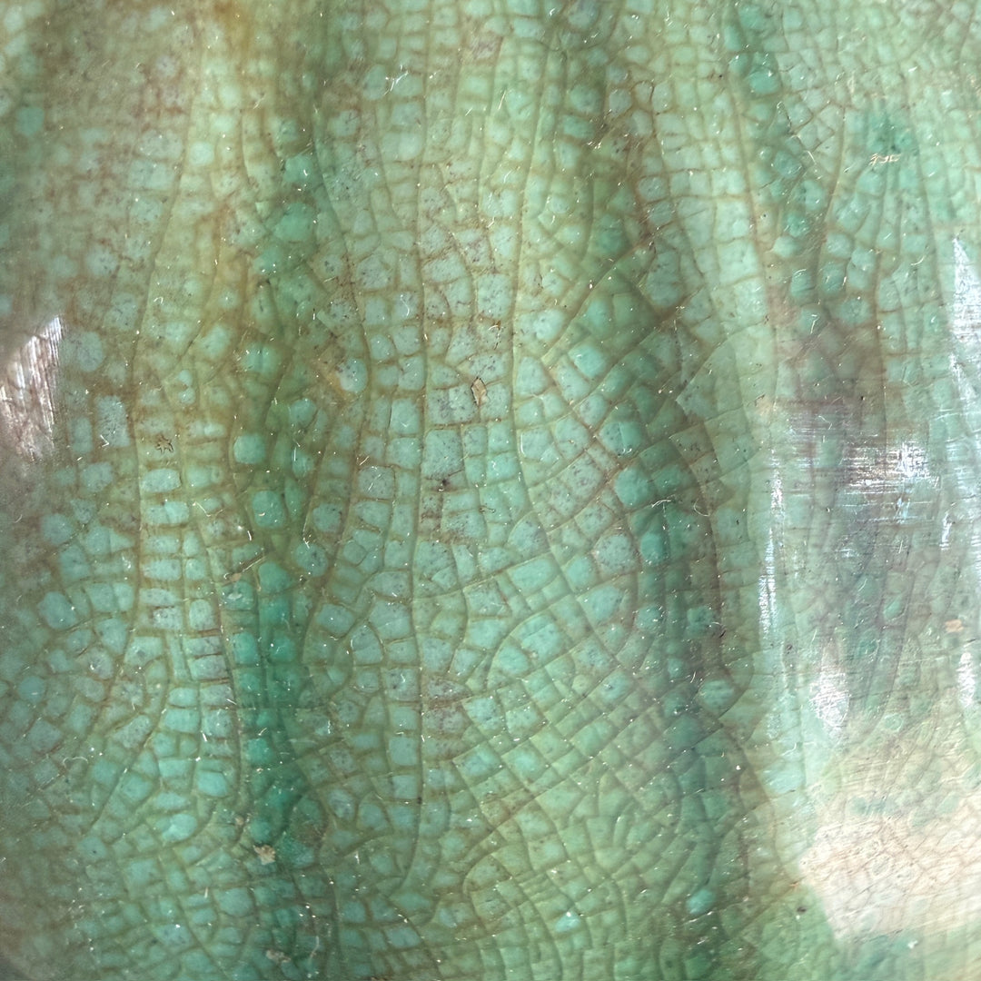 Detailed view of the green crackle glaze on a handcrafted stoneware temple jar, highlighting its unique artisan finish and subtle tonal variation.
