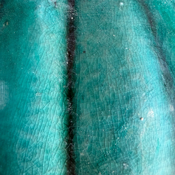 Close-up of the rich green glaze and textured finish on a handcrafted stoneware temple jar inspired by traditional Chinese ceramics.
