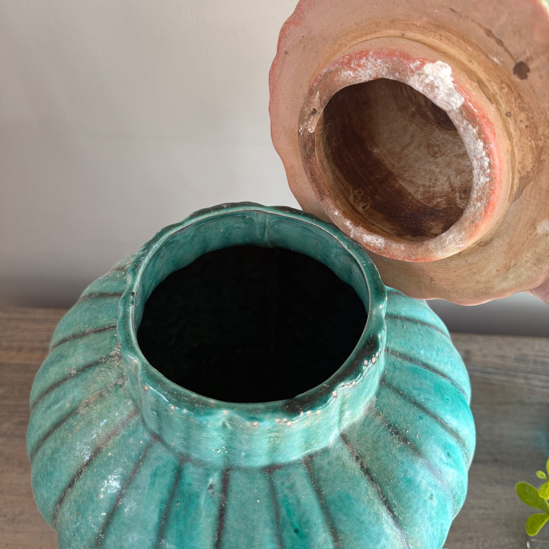 Interior view of a handcrafted green glazed stoneware temple jar with removable lid, revealing its traditional stoneware construction.
