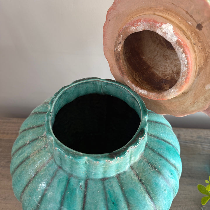 Interior view of a handcrafted green glazed stoneware temple jar with removable lid, revealing its traditional stoneware construction.
