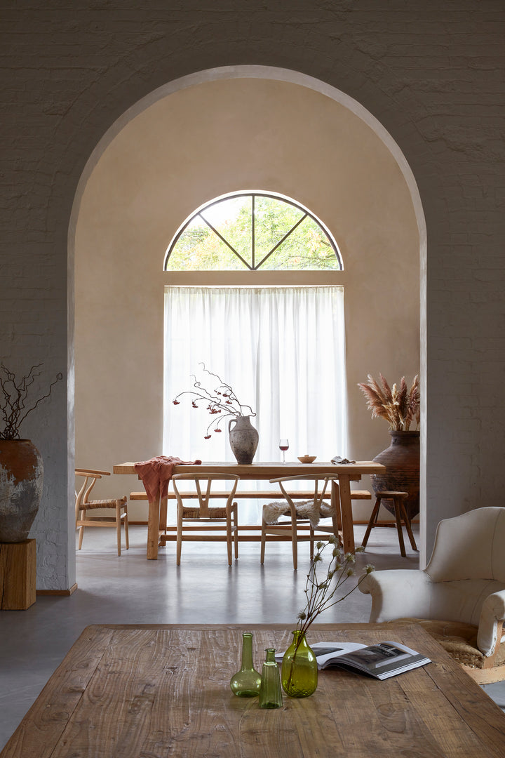 Hand Crafted Salvaged Dining Table within a large arch doorway