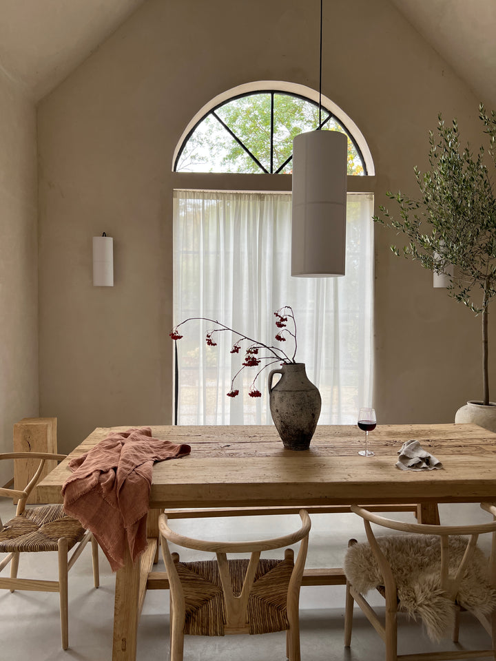 Hand Crafted Salvaged Dining Table close up in front of arched window