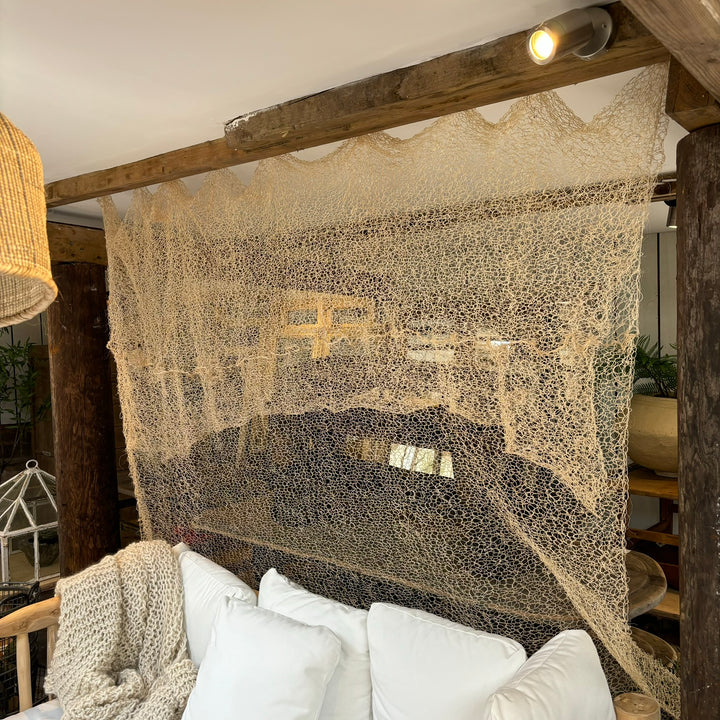 Hand knitted sisal curtain displayed hanging in the Home Barn garden room