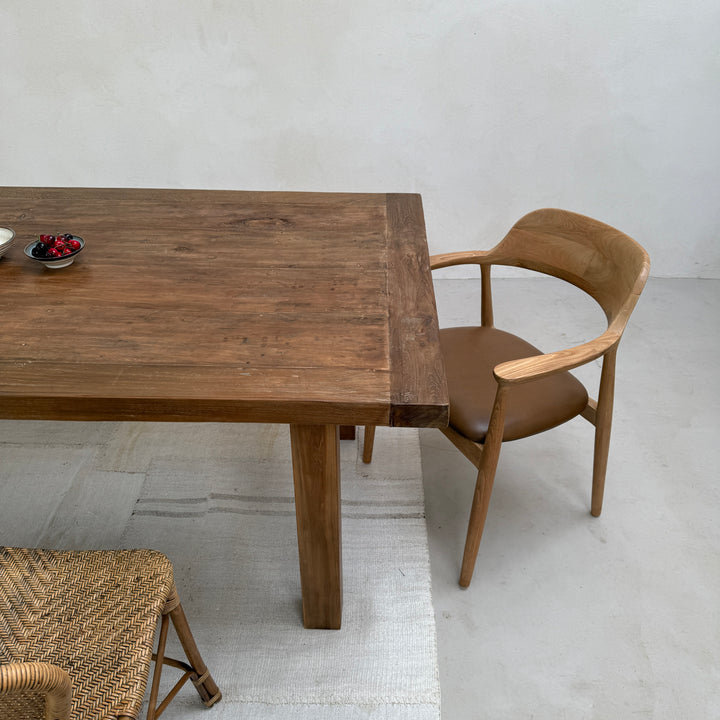 Corner view of the Henley reclaimed teak dining table highlighting the substantial solid teak legs and beautifully aged reclaimed timber.