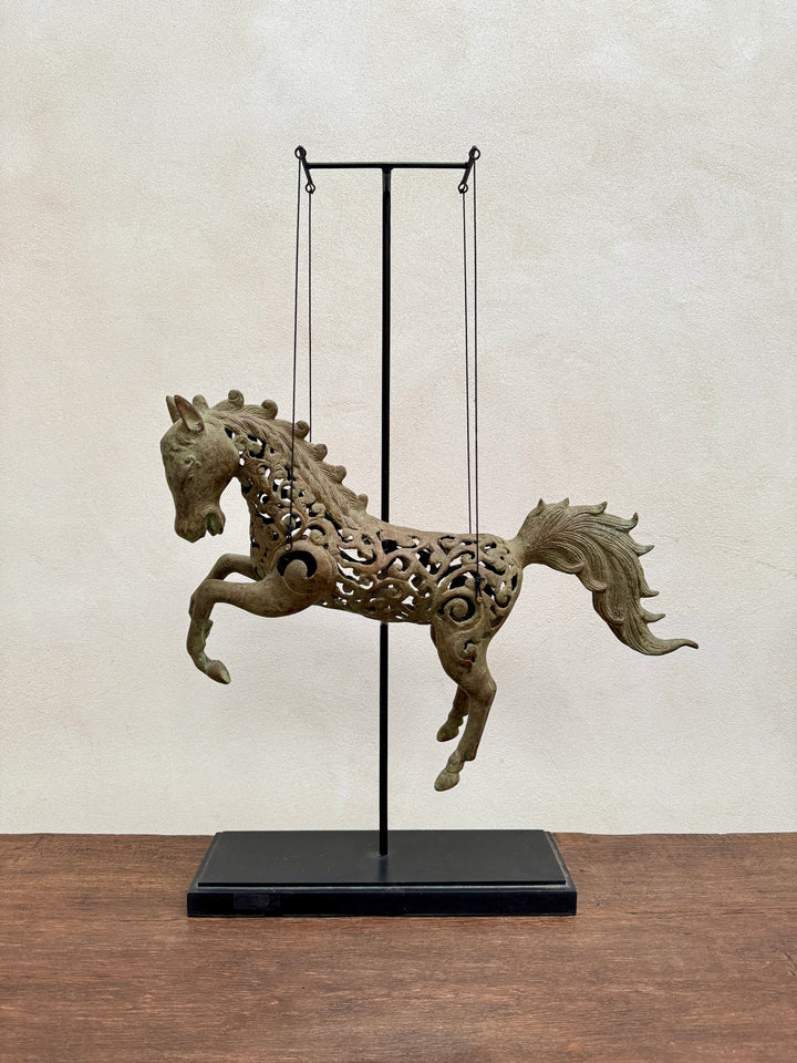 Large suspended bronze horse on stand