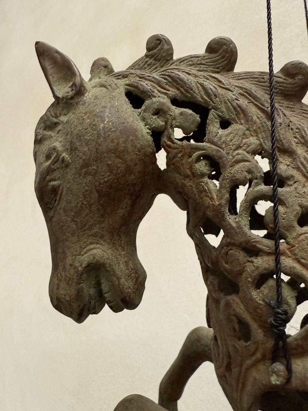 Large suspended bronze horse on stand