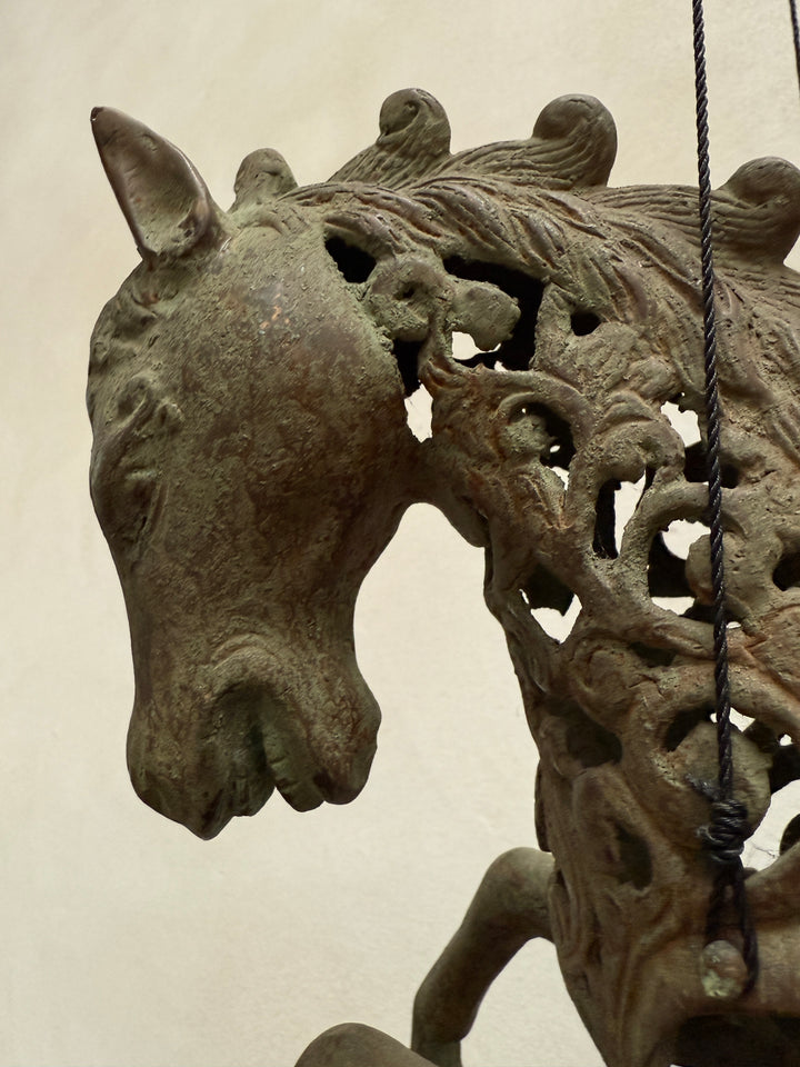 Large suspended bronze horse on stand