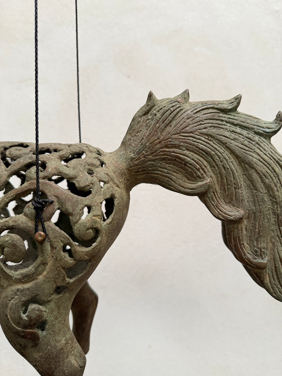 Large suspended bronze horse on stand