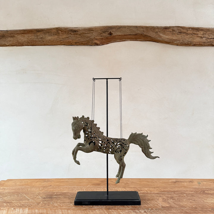 Large suspended bronze horse on stand