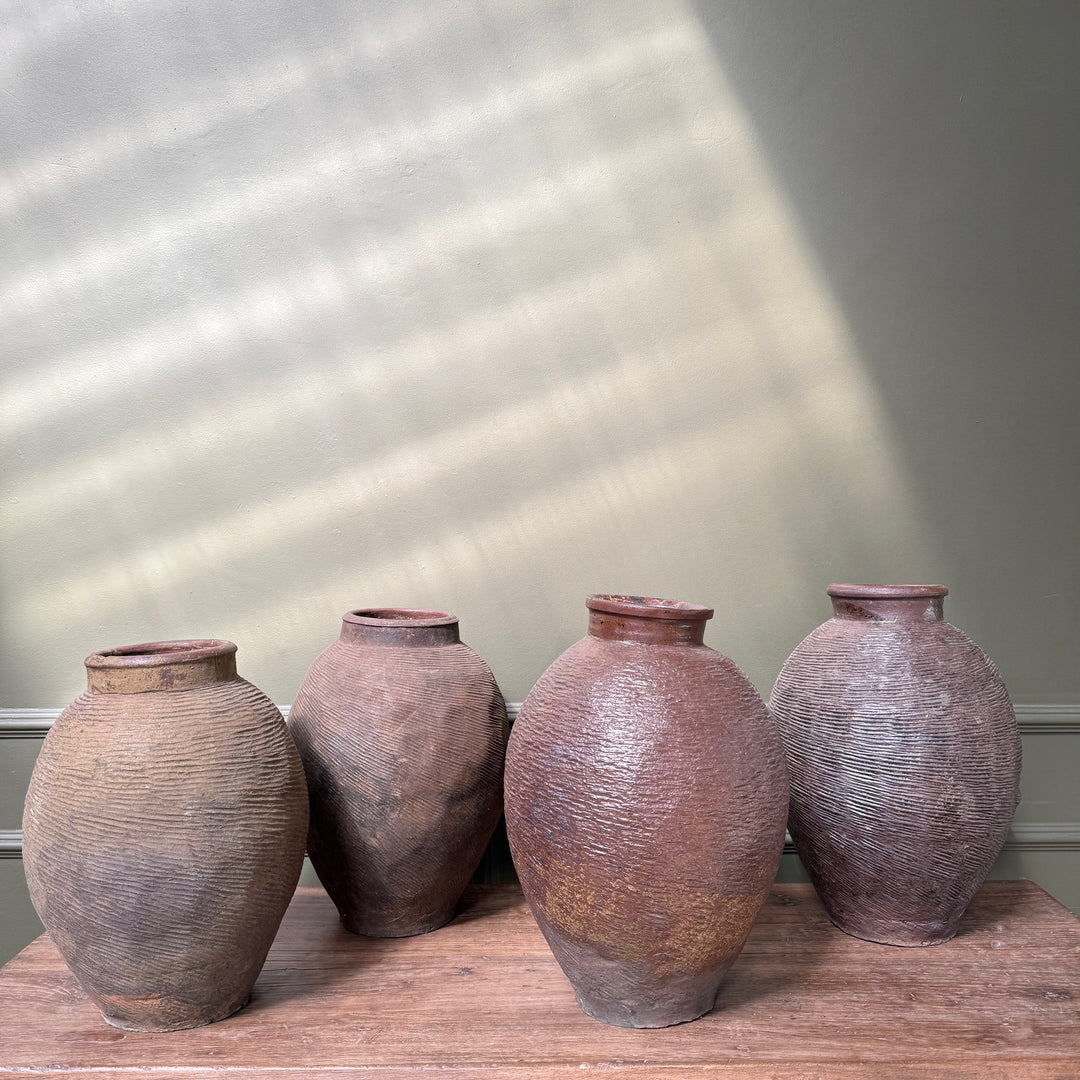 Collection of authentic antique Chinese stoneware storage jars, each handcrafted with unique colour, texture and historic character.
