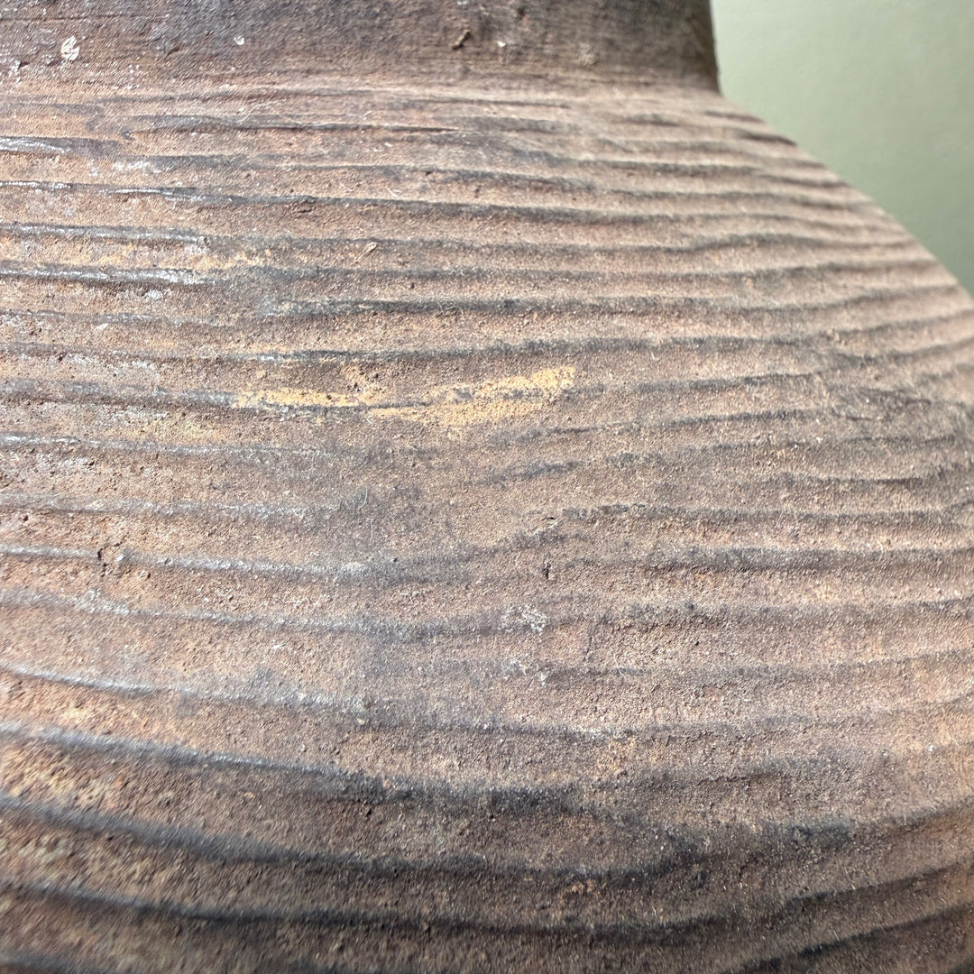 Close-up of the naturally weathered stoneware surface with traditional combed decoration and rich iron clay tones.
