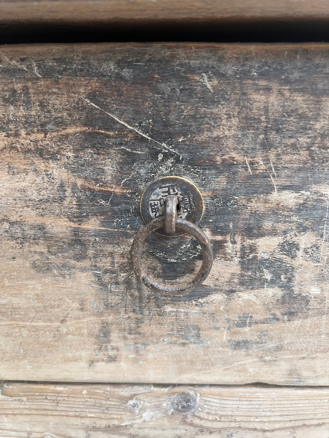 Close-up of a rustic wooden door with a metal handle