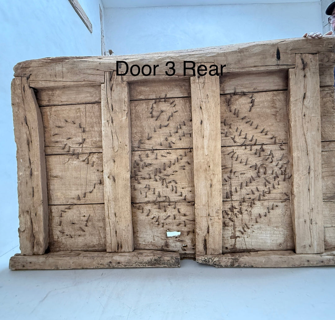 Wooden door with visible termite damage on a white background