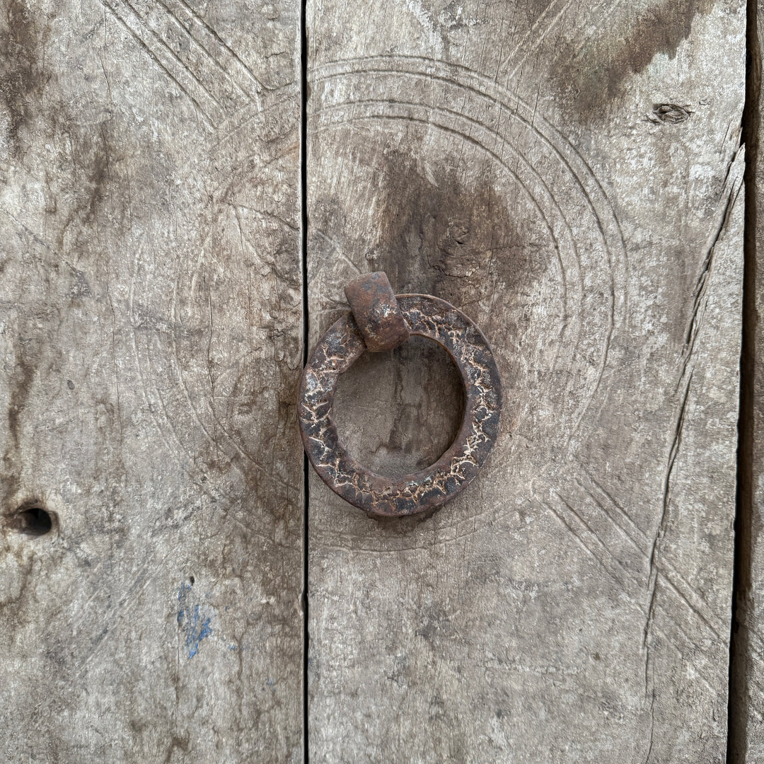 Rustic metal ring on a textured wooden surface