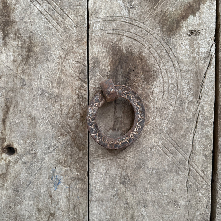 Rustic metal ring on a textured wooden surface