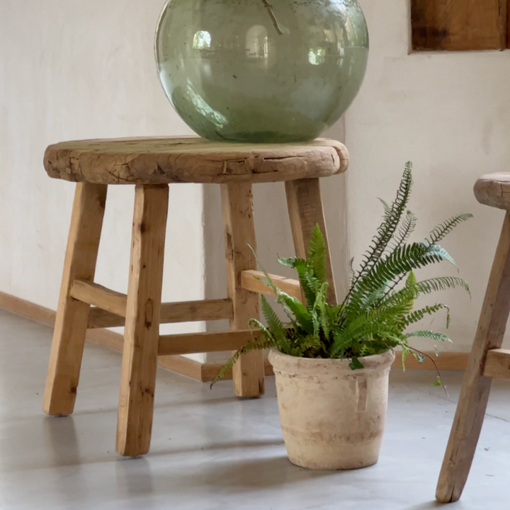 Large reclaimed elm round side table in a living room