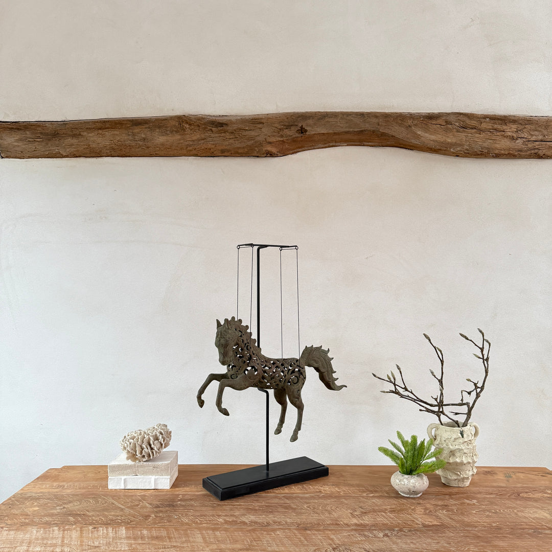 Large suspended bronze horse on stand