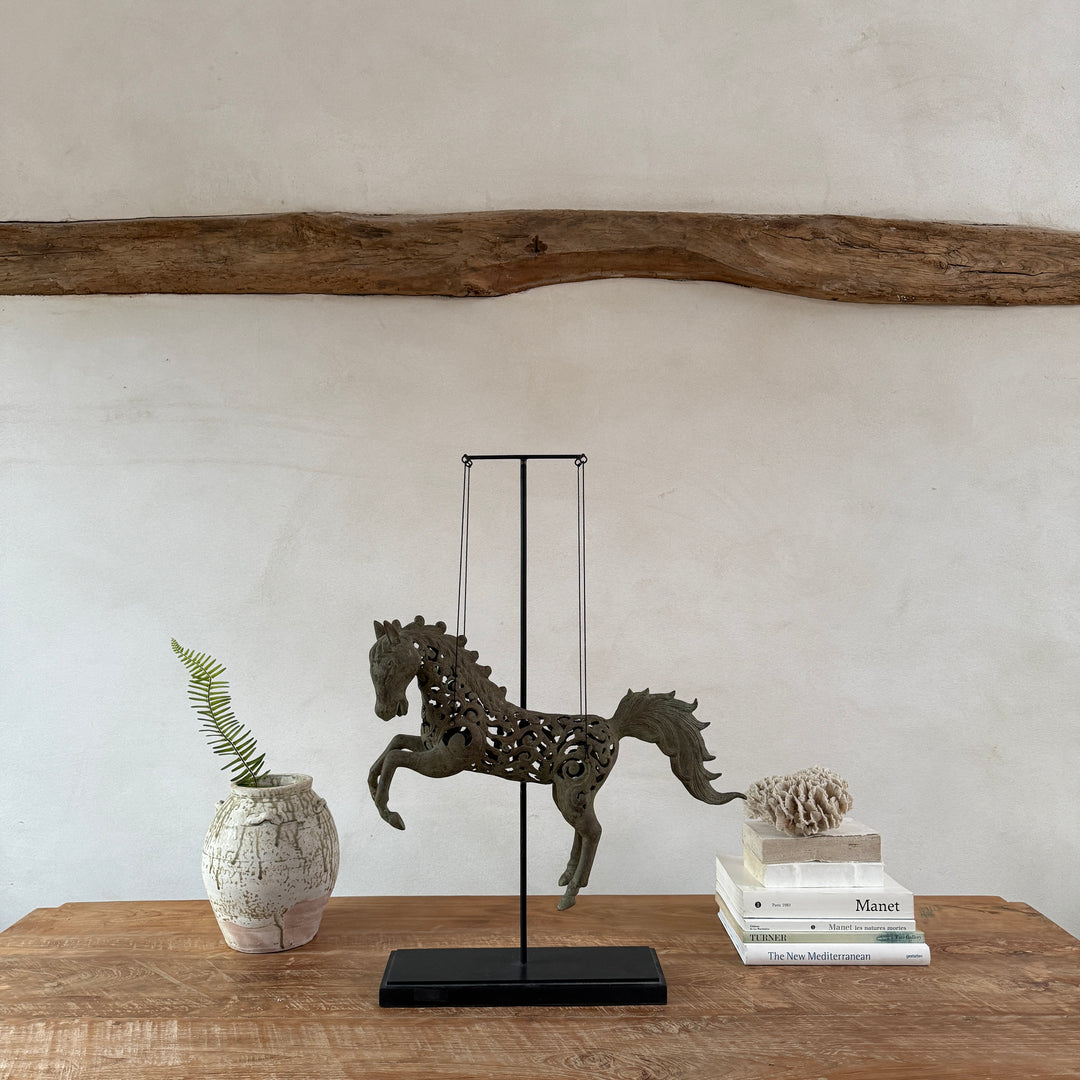 Large suspended bronze horse on stand