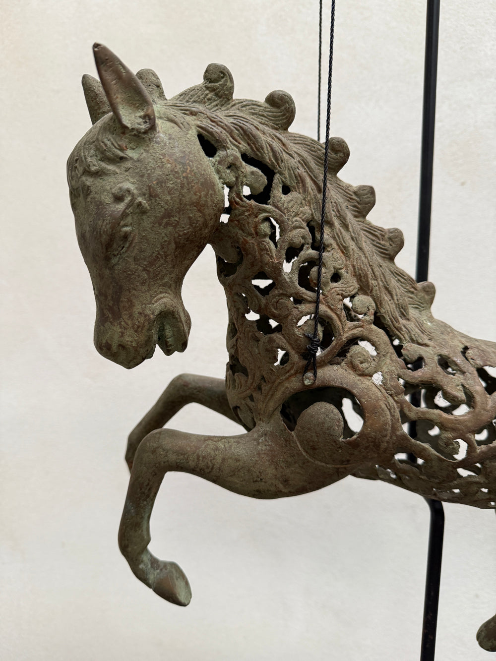 Large suspended bronze horse on stand