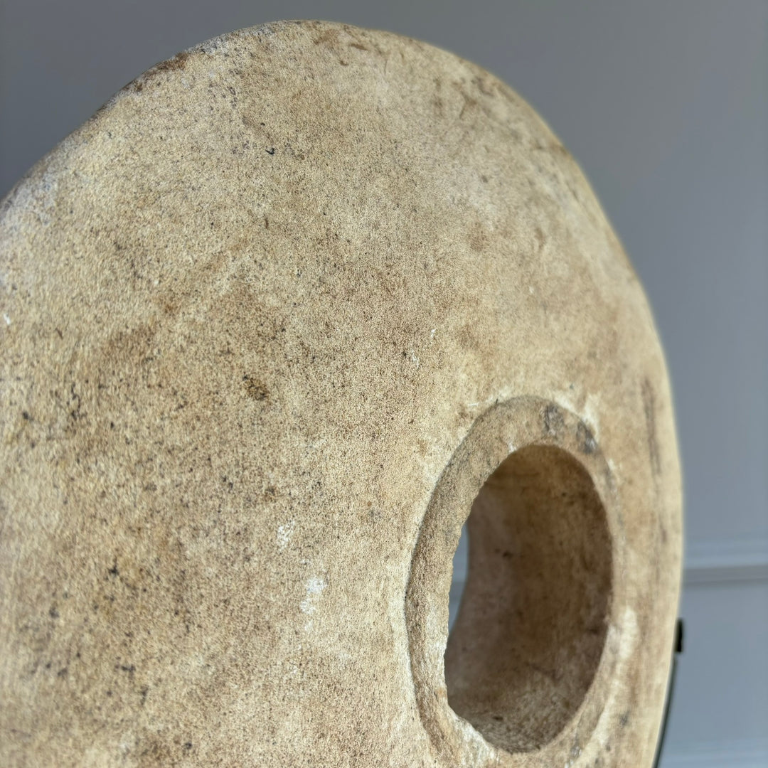 Large sandstone disc on stand