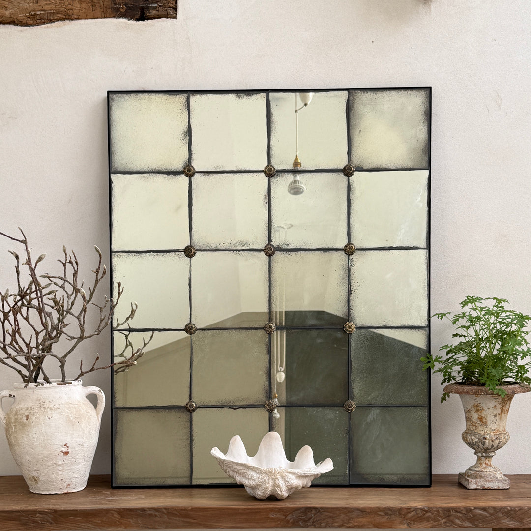 Large Leonora antiqued window mirror with foxed glass leaning on a reclaimed console table, perfect for hallways, living rooms and contemporary country interiors.