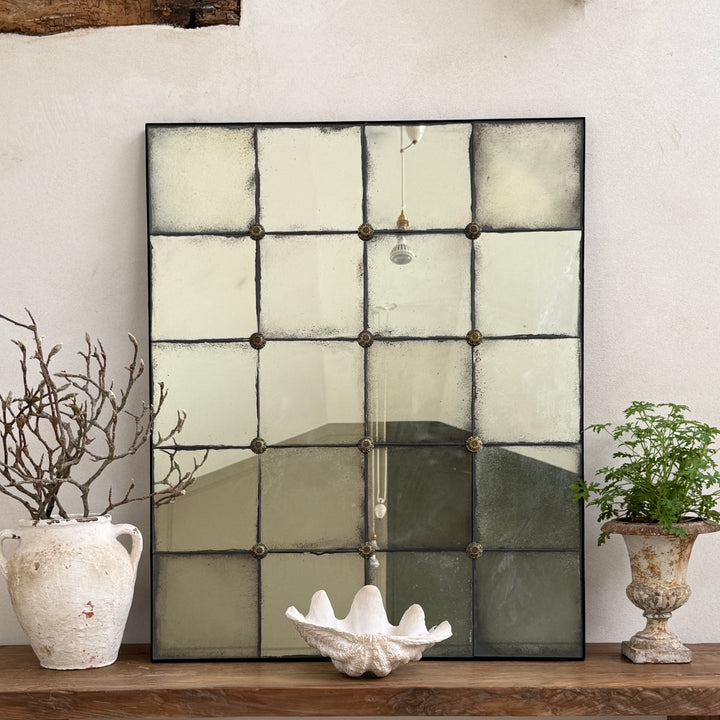 Large Leonora antiqued window mirror with foxed glass leaning on a reclaimed console table, perfect for hallways, living rooms and contemporary country interiors.