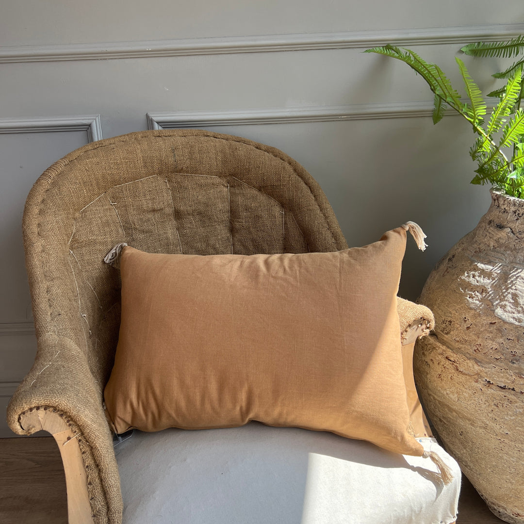 Linen cushion with tassels Autumn on armchair