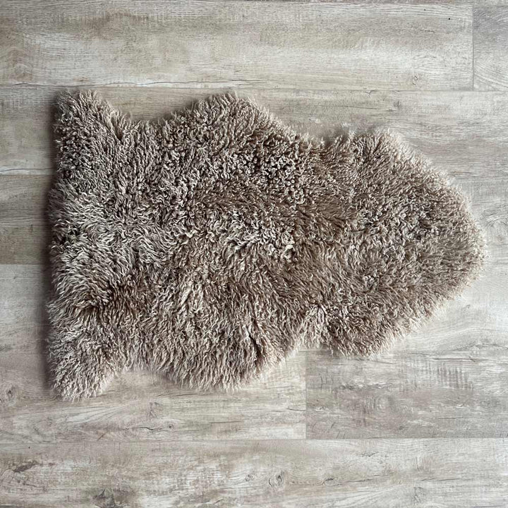 Natural sheepskin throw rug on floor from above