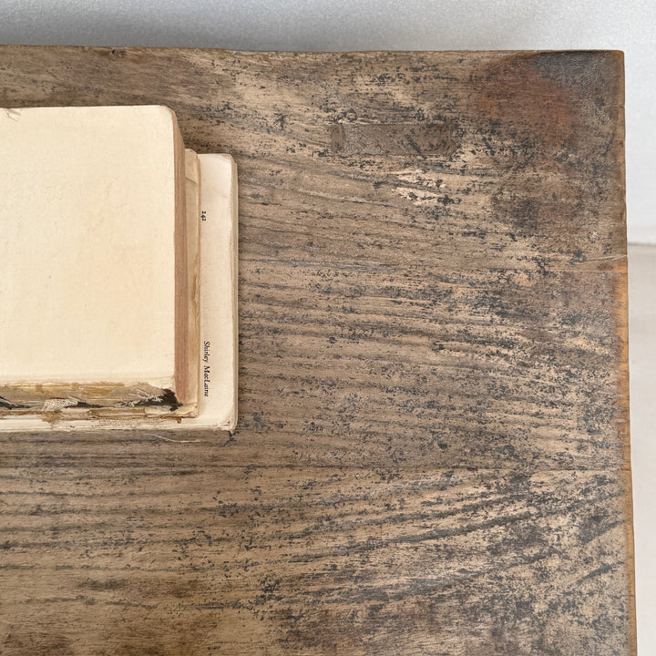 Close-up of a wooden surface with an open book