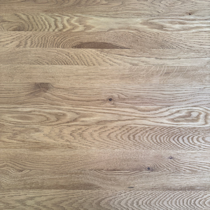 zoomed in imae of reclaimed American oak tabletop showing distinctive grain patterns, warm tonal variation and natural timber markings.