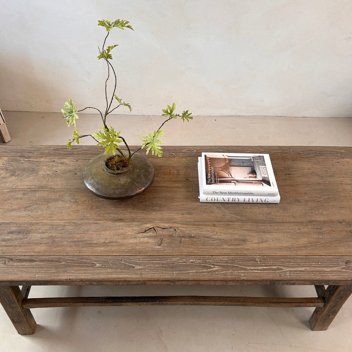 Detailed view of the reclaimed elm surface revealing natural knots, historic markings and the rich texture that makes every coffee table one of a kind.