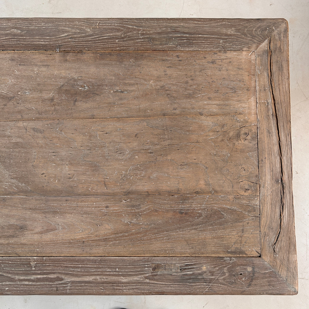 Close-up of the reclaimed elm tabletop displaying beautiful grain patterns, subtle colour variation and the authentic character developed over decades of use.