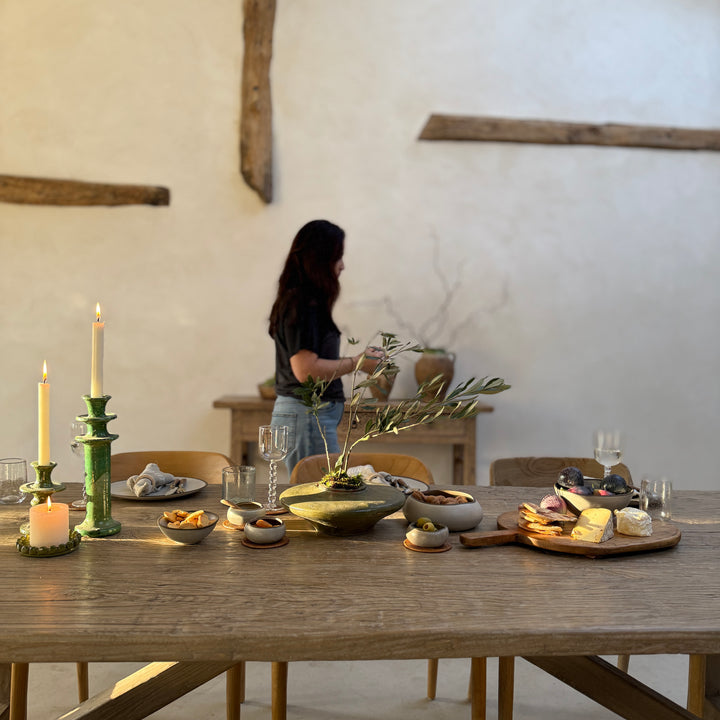 Reclaimed Elm Farmhouse Dining Table Cambridge styled for relaxed entertaining, showcasing the characterful reclaimed elm tabletop and generous proportions. Crafted from salvaged timber, this rustic dining table provides a welcoming setting for gathering, sharing meals and everyday family life.