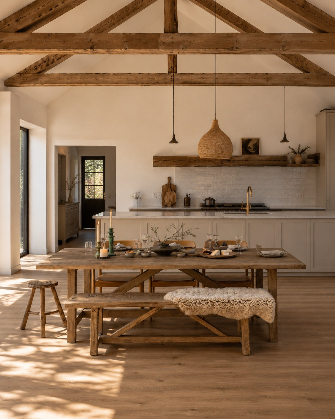 Reclaimed Elm Farmhouse Dining Table Cambridge with matching bench, styled within a light-filled modern barn kitchen. Crafted from salvaged elm timber with a rustic farmhouse design, creating a warm and welcoming space for family dining, entertaining and everyday living.
