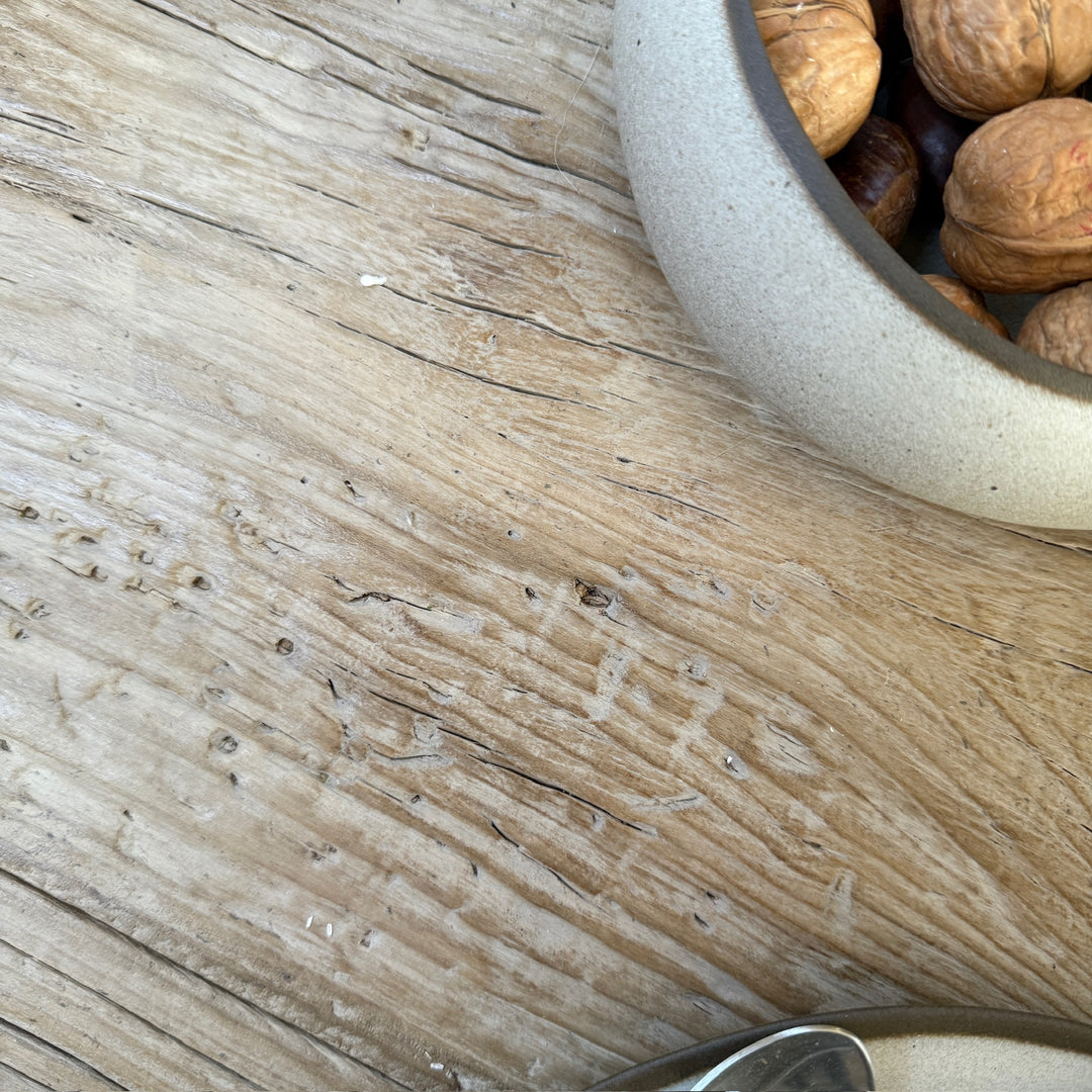 Close-up of the Reclaimed Elm Farmhouse Dining Table Cambridge showing the natural grain, historic markings and textured surface of salvaged elm timber. The characterful reclaimed wood displays authentic knots, aged patina and individual variations that make every dining table unique.