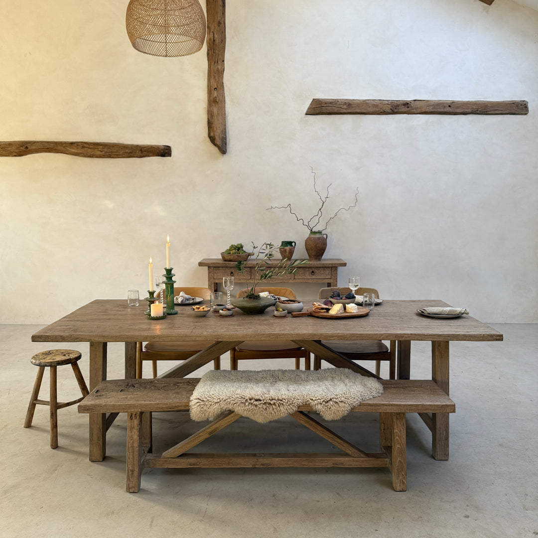 Reclaimed Elm Farmhouse Dining Table Cambridge with matching reclaimed wood bench, styled in a rustic modern barn interior. Crafted from salvaged elm timber with a characterful farmhouse design, ideal for family dining, entertaining and open-plan kitchen living.