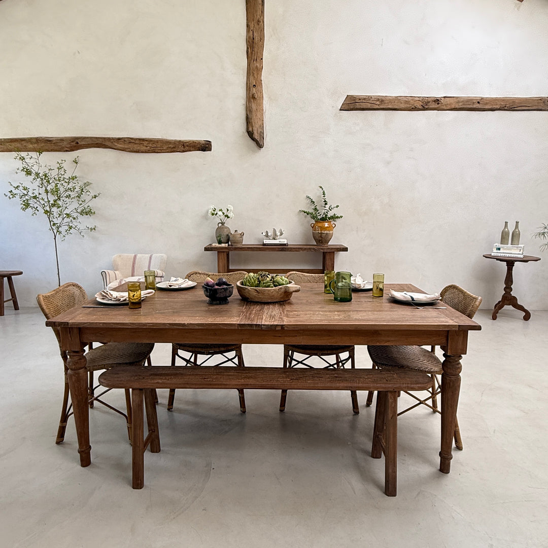 Rear perspective of the reclaimed extending dining table showcasing its substantial construction, elegant silhouette and handcrafted reclaimed teak from every angle.