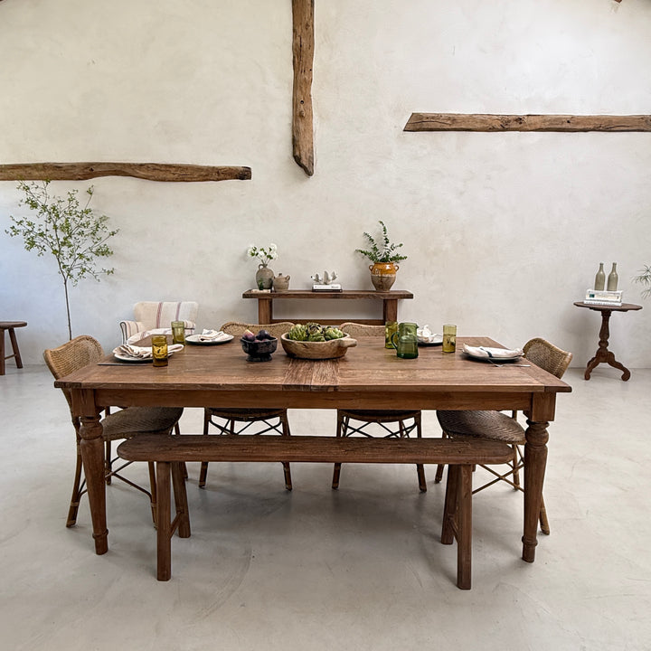 Rear perspective of the reclaimed extending dining table showcasing its substantial construction, elegant silhouette and handcrafted reclaimed teak from every angle.