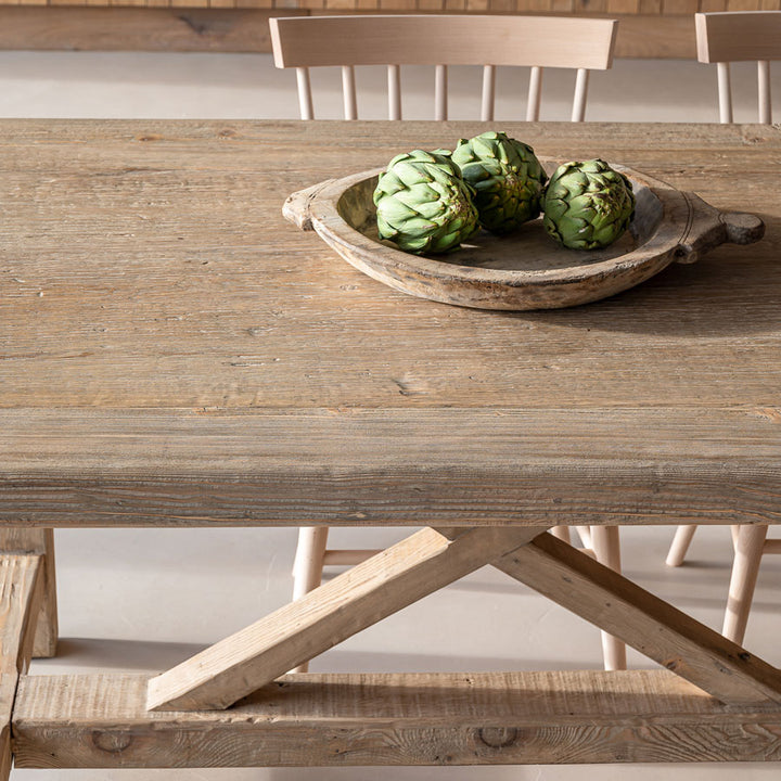 Reclaimed pine dining table top showing the wide perimeter plank and naturally varied timber grain