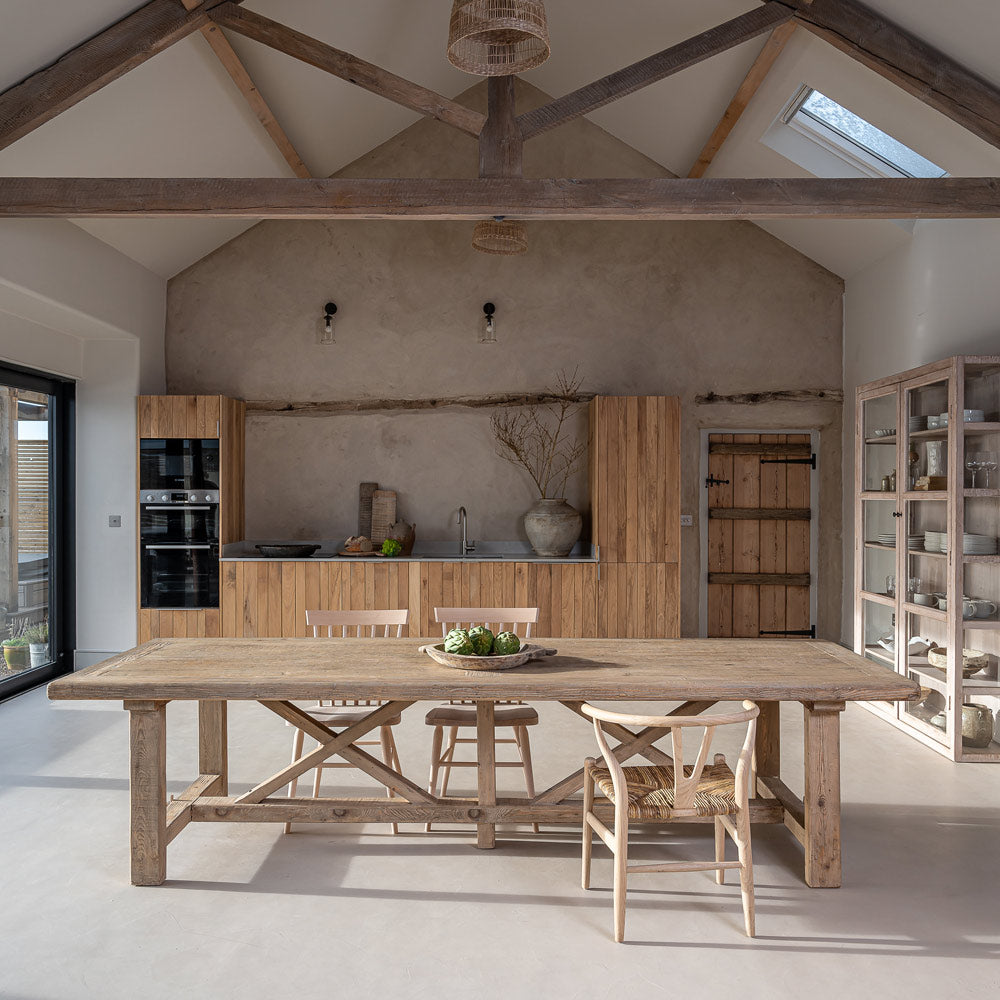 Large reclaimed pine refectory dining table in a luxury contemporary country kitchen