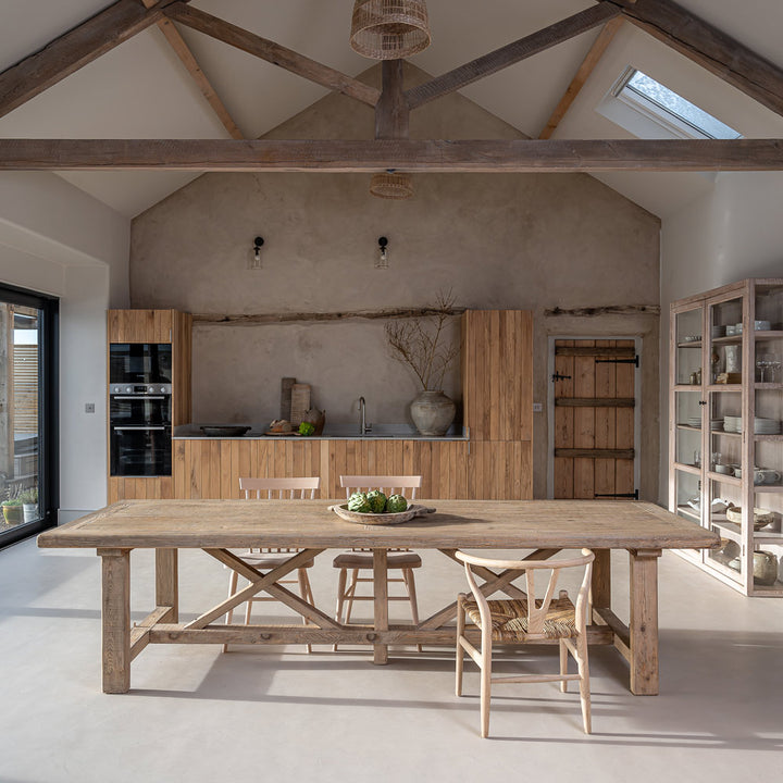 Large reclaimed pine refectory dining table in a luxury contemporary country kitchen