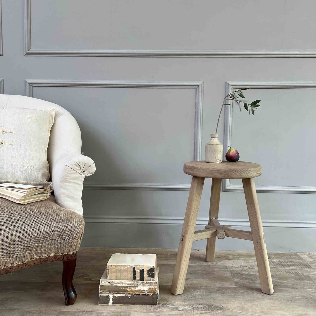 Reclaimed Round stool St Ives beside an armchair