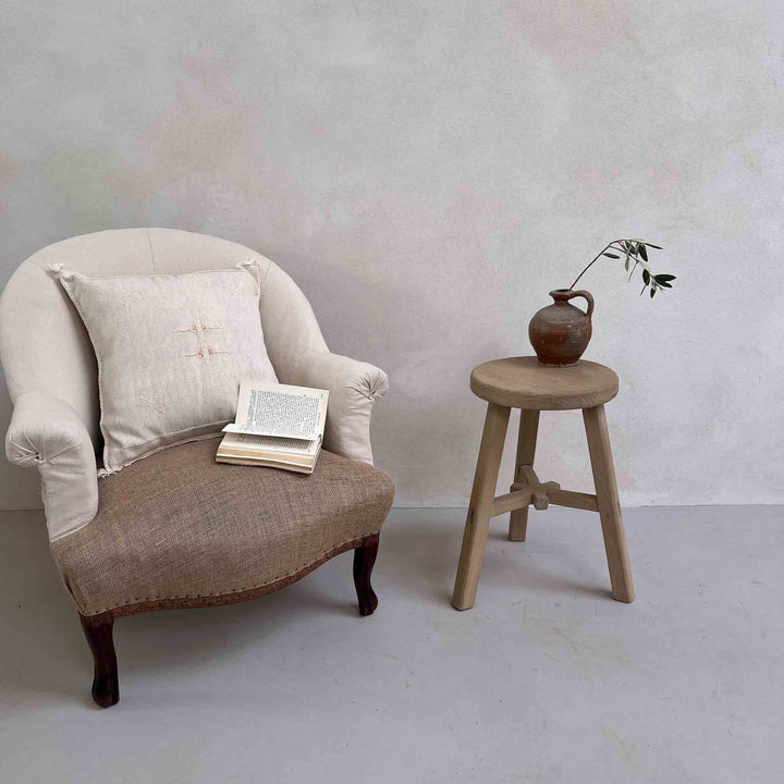 Reclaimed Round stool St Ives beside armchair