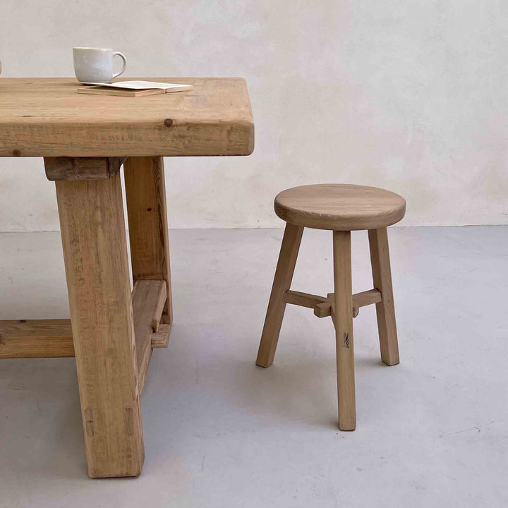 Reclaimed Round stool St Ives at the dinibg table