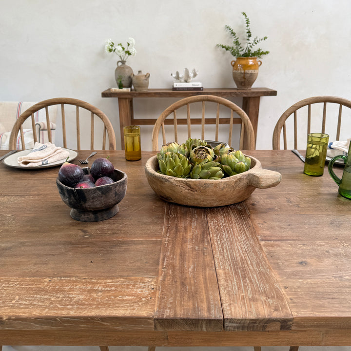 A beautifully styled tablescape on the reclaimed teak dining table featuring artisan ceramics and seasonal produce, celebrating the warmth, texture and natural character of salvaged teak.