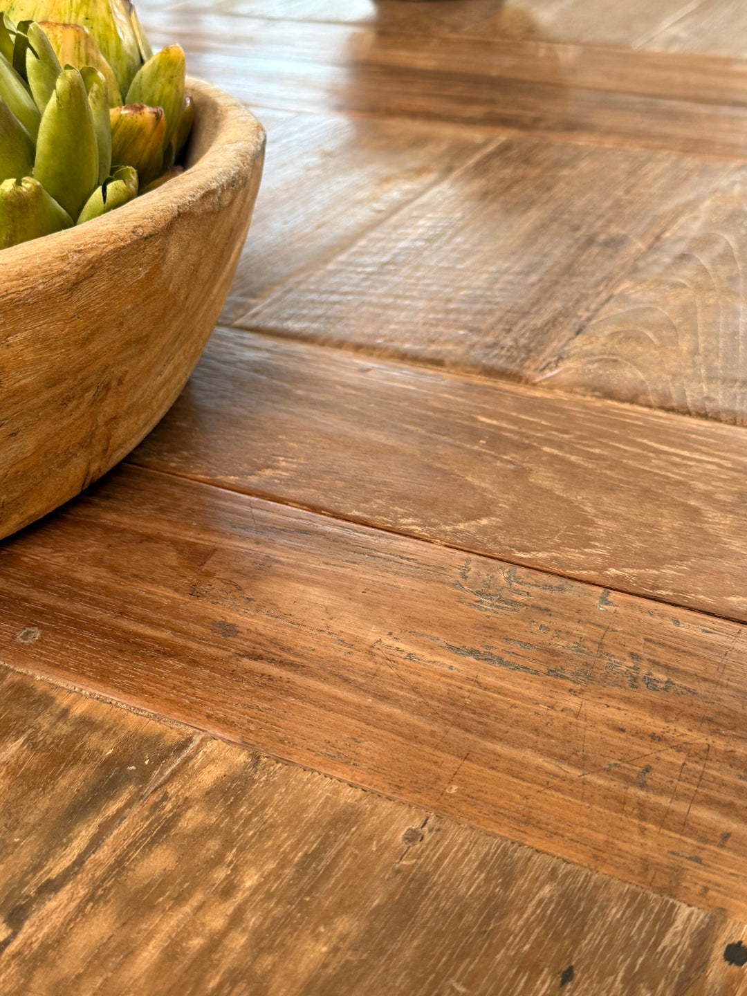 Close-up of the reclaimed teak extension leaf showing carefully matched timber, handcrafted construction and the seamless finish of this extending dining table.
