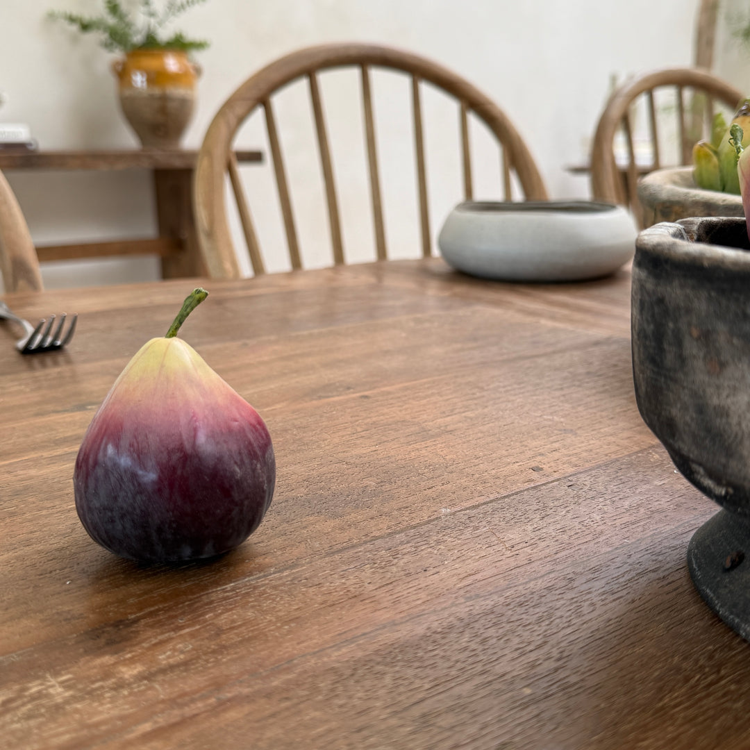 The reclaimed teak dining table paired with classic Windsor chairs, demonstrating comfortable seating and timeless proportions for relaxed family dining.