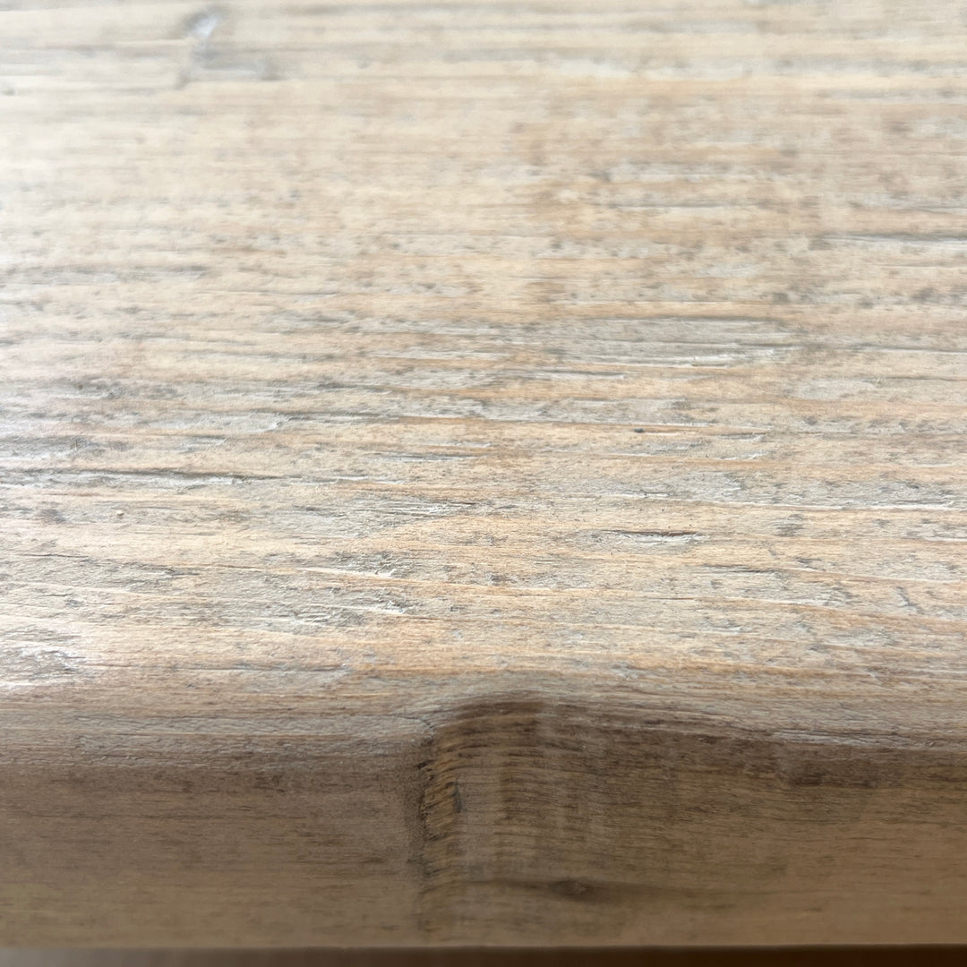 Close up of rustic reclaimed pine dining table highlighting natural grain texture and timeworn character
