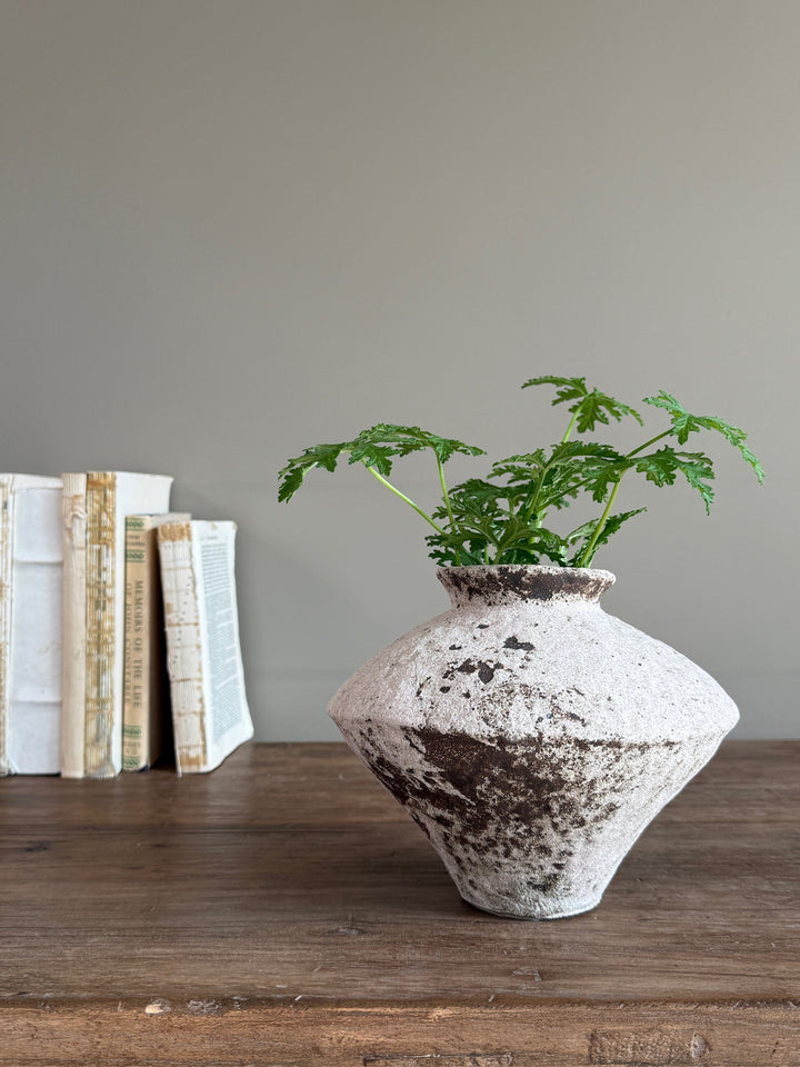 Side view of the Rustic Stoneware Decorative Vase featuring its beautifully weathered finish and handcrafted sculptural form.
