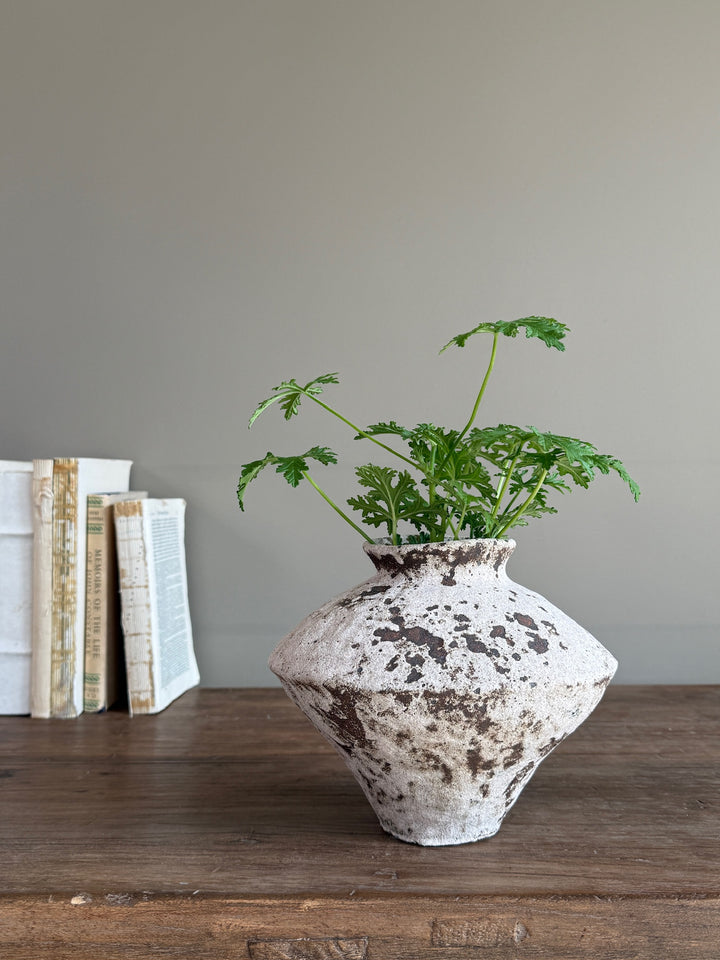Rustic stoneware decorative vase displayed with faux greenery, demonstrating its timeless proportions and relaxed styling for contemporary country homes.
